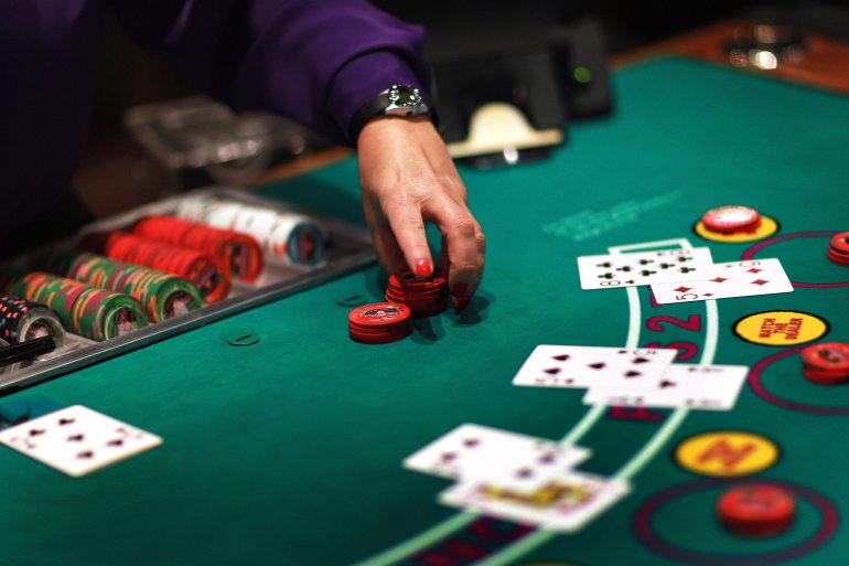 Playing blackjack croupier takes bets