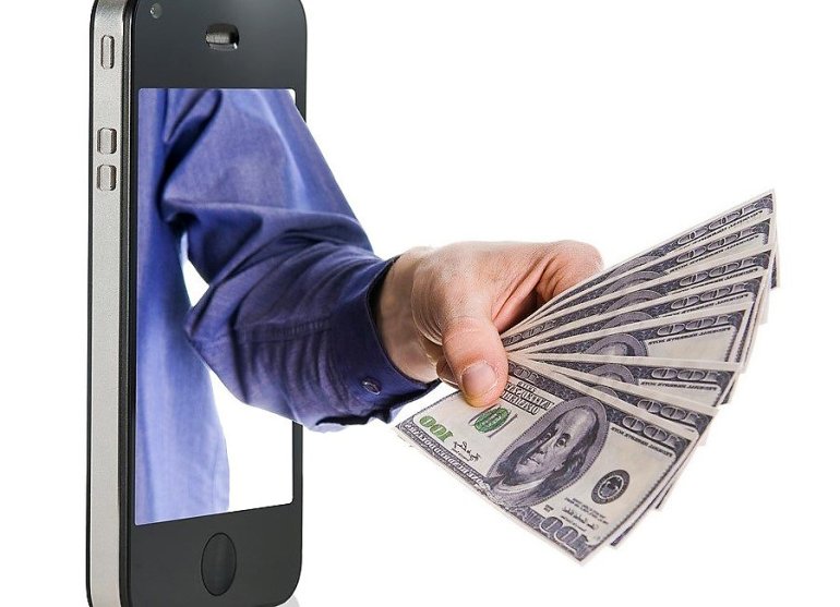A hand from the phone screen with $100 banknotes