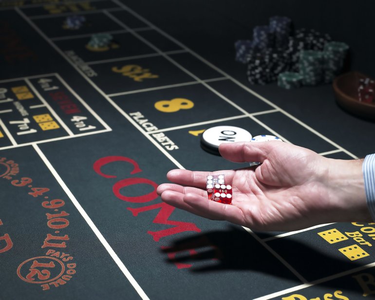A player holds craps dice