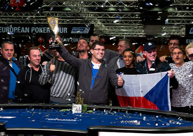 Male player with a winner's tournament cup won and a major chip win