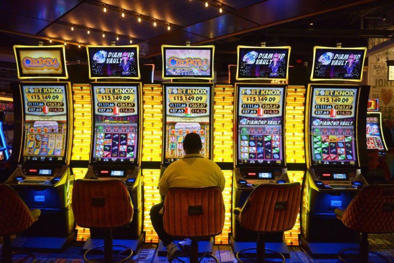 an obese gambler playing video slots
