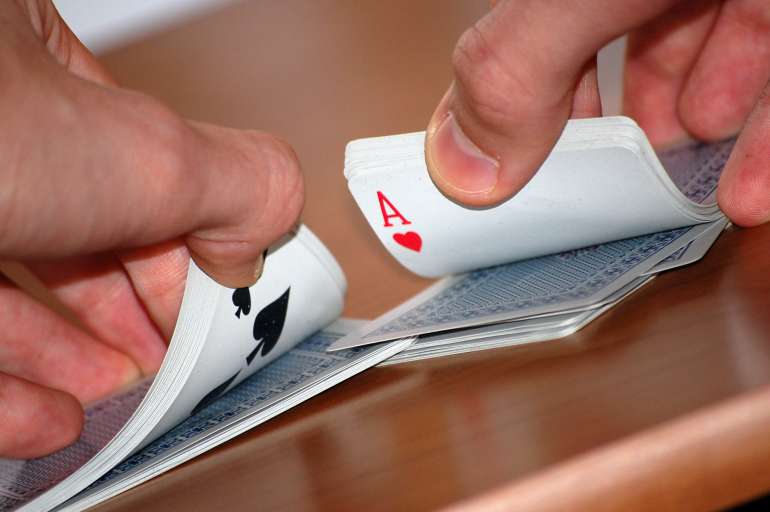 Shuffling cards by casino dealer in Shuffle Shuffle in Shuffle