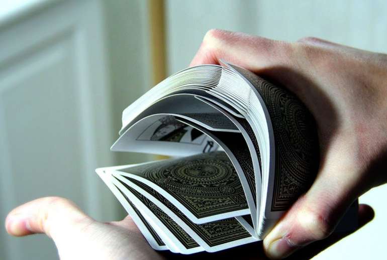 A deck of cards in the hand of a professional in Sharper Cards in the sharper's hand in Sharper